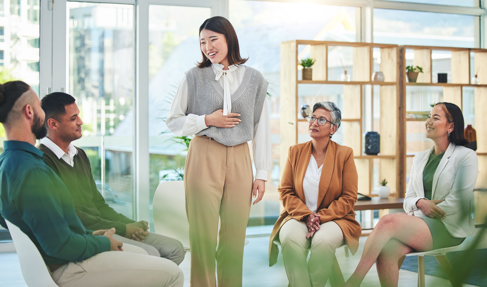 Support, group and psychology of Asian woman talking in meeting, conversation and wellness. Counseling, therapy and happy people speaking, community help and rehabilitation, mental health and healing